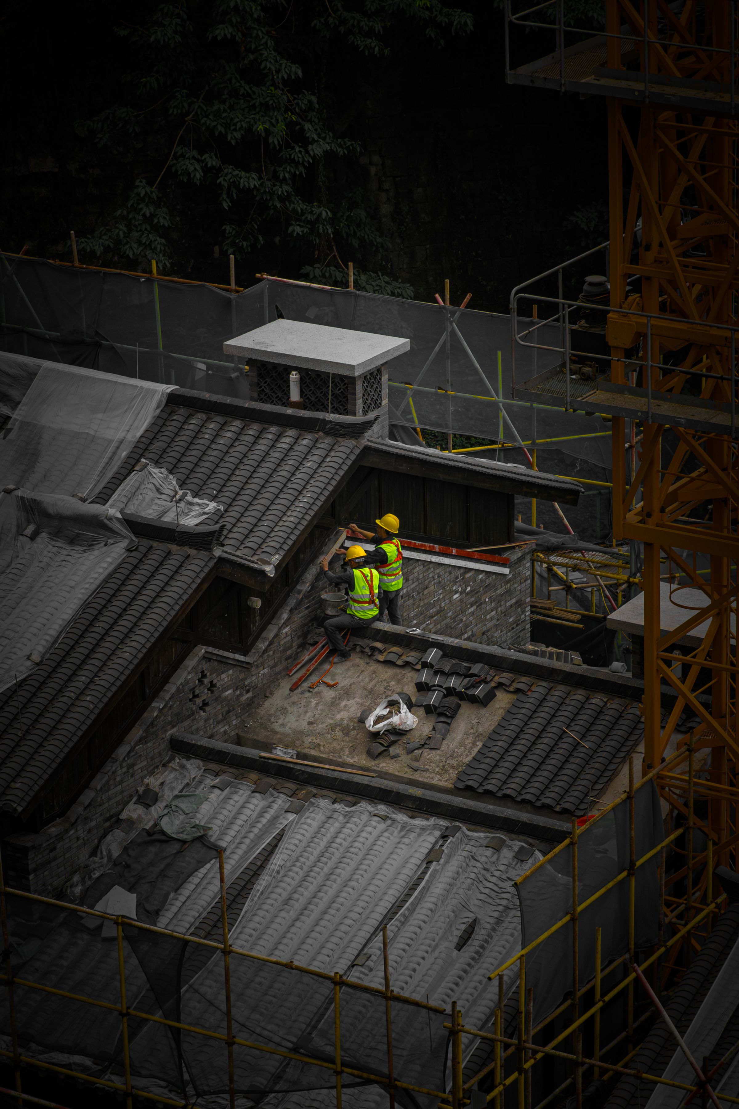 High-visibility construction workers operating on an elevated building site